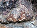 Banded iron-formation over basement rocks (Archean; Route 17 roadcut east of Bridget Lake, south of Wawa, Ontario, Canada) 39 (48270359682).jpg