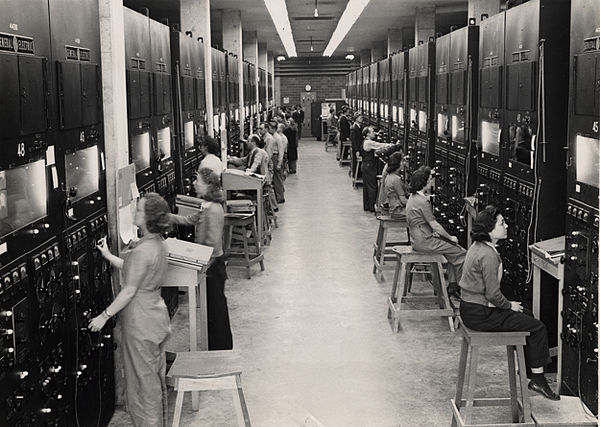 Control panels and operators for calutrons at the Oak Ridge Y-12 Plant. The operators, mostly women, worked in shifts covering 24 hours a day.