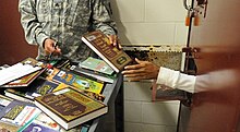 Library books, Guantanamo prison, 2011 Captive browses books at Camp 5 Guantanamo.jpg