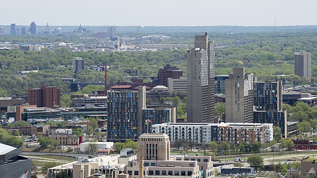 High-rise buildings in Minneapolis's Cedar-Riverside neighborhood, with the Downtown Saint Paul skyline visible in the background. Minneapolis' city l