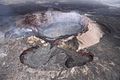 English: Lava erupting out of the crater of Puʻu ʻŌʻō volcanic cone of Kilauea volcano in Hawaii, USA. This photo was taken about one hour after this photo. The lava level had risen about 3 metres in that hour, high enough to spill over the pond walls and expand across the crater floor.