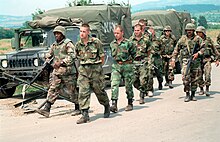 A file of flex-cuffed prisoners of war being forcibly marched DM-SD-01-04516 - Yugoslav EPWs in Kosovo being escorted by U.S. Marines over to Yugoslav authorities.jpg