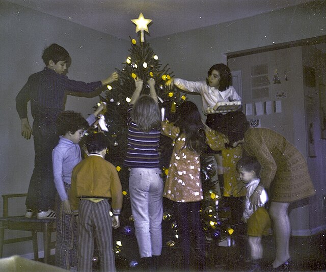 Typical North American family decorating Christmas tree (c. 1970s)