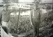 Lawrence "Paca" Dufrene and Abel Theriot at Delta Farms, 1930s Delta Farms sign.jpg