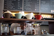 Coffee drips through coffee grounds and filters into several jars in a specialty coffee shop. Drip Coffee Bangkok.jpg