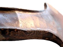 Raking light allows the viewer to see hammering scars that are not evident in standard lighting conditions. Early Bronze Age, Arreton Type Developed Flat Axehead (FindID 139019-194932).jpg