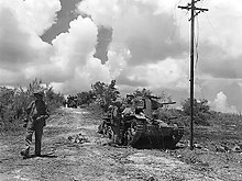 Marines inspect a knocked out Japanese tank Japanese tank knocked out of action - Tinian.jpg