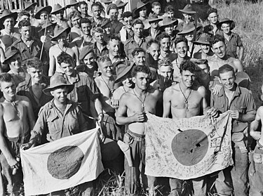 Members of the 2/6th display Japanese flags captured during the Battle of Kaiapit Kaiapit flags 057510.jpg