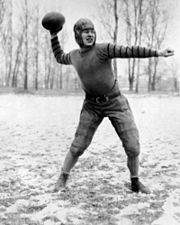 Coach Curly Lambeau, top, center, appears tense during a play in