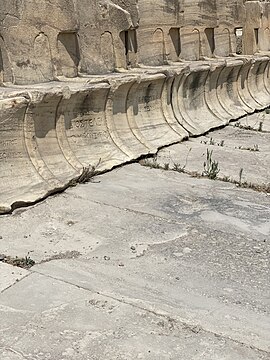 Marble seats at the Theatre of Dionysus inscribed with names.