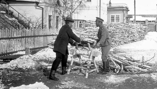 Pierre Gilliard (left) and Nicholas II sawing wood while in exile at Tobolsk, winter 1917–18