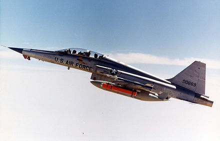 USAF F-5F with AIM-9J Sidewinder, AGM-65 Maverick missiles and auxiliary fuel tanks over Edwards Air Force Base, 1976.