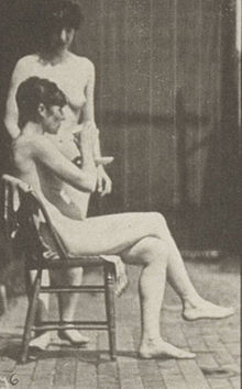 File:Nude woman brings a cup of tea; another takes the cup and