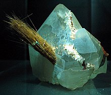 Acicular crystals of rutile protruding from a quartz crystal Rutile needles.jpg