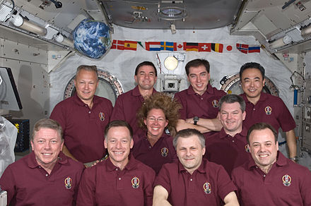 Shuttle and Station crew members pose for a portrait.
