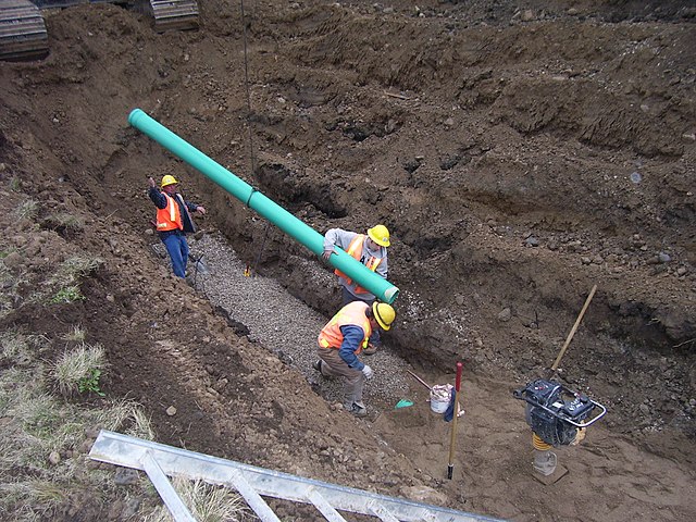 Gravity sewer installation illustrating the significant excavation depth often required to maintain a favorable gradient.