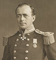 Man with receding hairline, looking left, wearing naval uniform with medals, polished buttons and large epaulettes