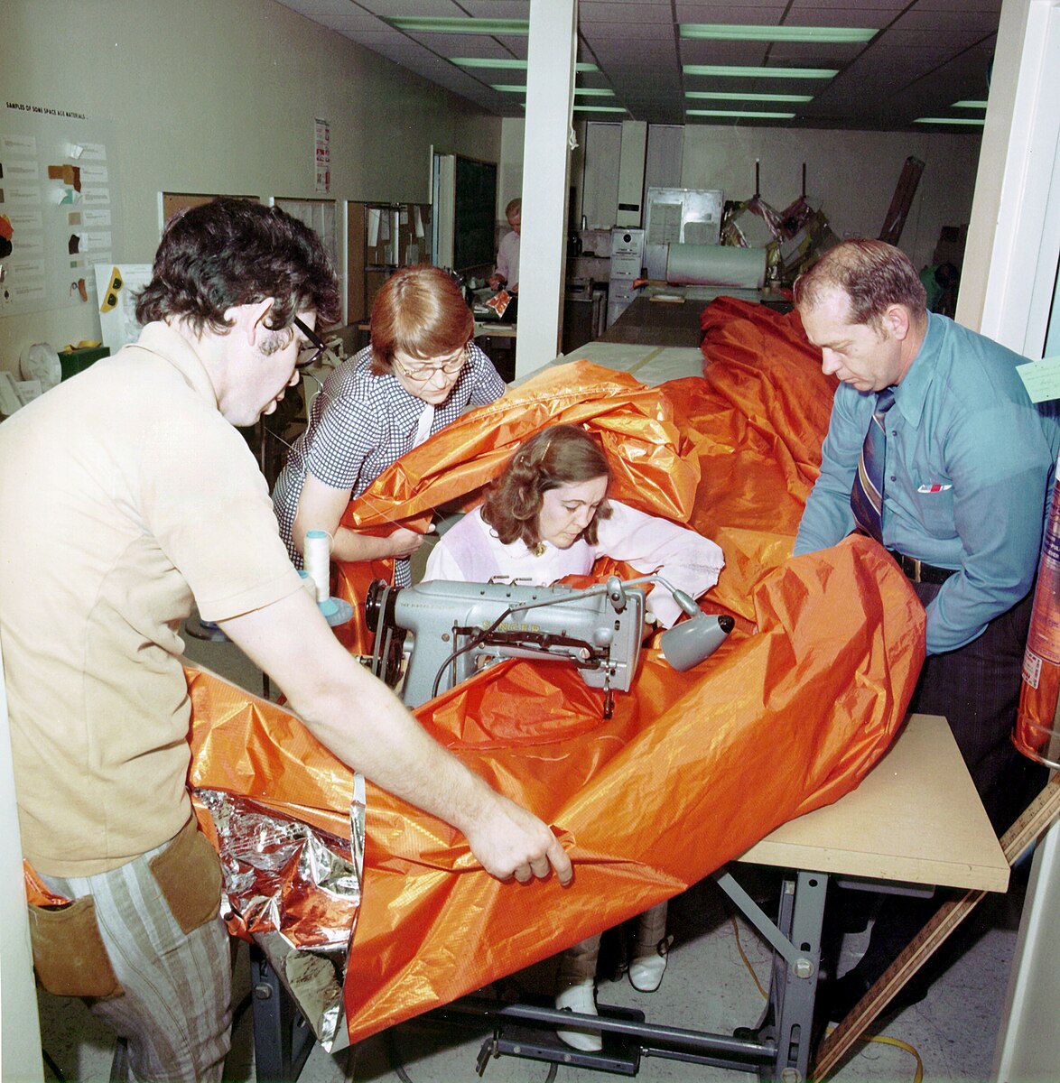 Working on the Skylab sunscreen, from left to right: Dale Gentry, Elizabeth Gauldin, Alyene Baker, and James H. Barnett Jr.; image via Wikimedia Commons