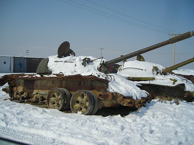 Russian Tanks covered with snow seen in Kabul are the left overs from the Soviet Union's Great Game in Afghanistan. The tank in the fore ground is T-54 or a T-55  while the one in the background is a T-62 as evidenced by the the barrel and the shape of th, From WikimediaPhotos