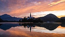 Sunrise at Lake Bled. The church on Bled Island has a 52-meter (171 ft) tower.