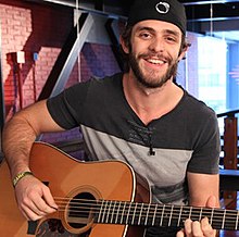 Country music singer Thomas Rhett, playing an acoustic guitar