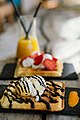 Top view dessert of ice cream, chocolate cake and strawberry juice on black dish in restaurant. (48961382923).jpg