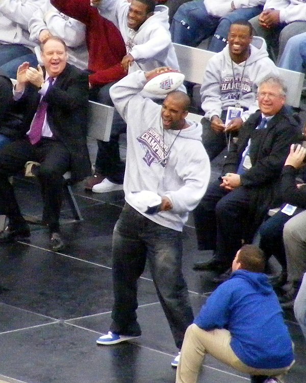 Tyree re-enacts his catch during the victory rally at Giants Stadium after the Super Bowl.