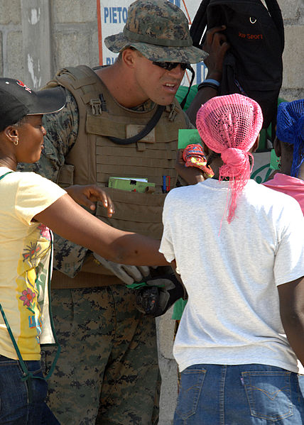 File:U.S. Marine Corps 1st Lt. Jeffery Cummings, with the 22nd Marine Expeditionary Unit, checks for a watermark on food tickets in Carrefour, Haiti 100216-N-HX866-011.jpg