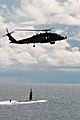 US Navy 070814-N-3136P-041 An HH-60H Seahawk from Helicopter Anti-Submarine Squadron (HS) 14 assigned to USS Kitty Hawk (CV 63) flies over USS Key West (SSN 722) prior to Valiant Shield's photo exercise.jpg