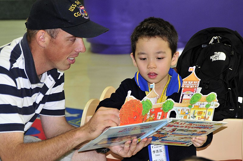 File:US Navy 081028-N-XXXXK-001 Fire Controlman 2nd Class Matthew B. Powell reads a children's book during a community relations project at the Hong Kong Society for the Protection of Children Nursery School.jpg