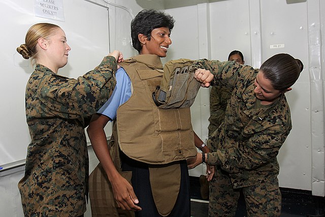 United States Marines in July 2010 assist a Sri Lanka Navy sailor in trying on a Modular Tactical Vest