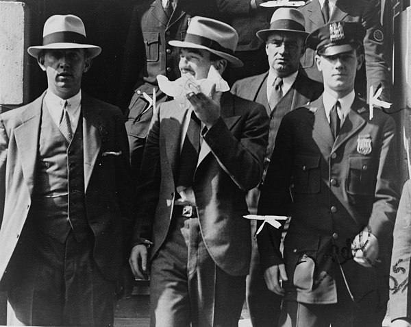 Mad Dog Coll leaving court surrounded by police officers, 1931
