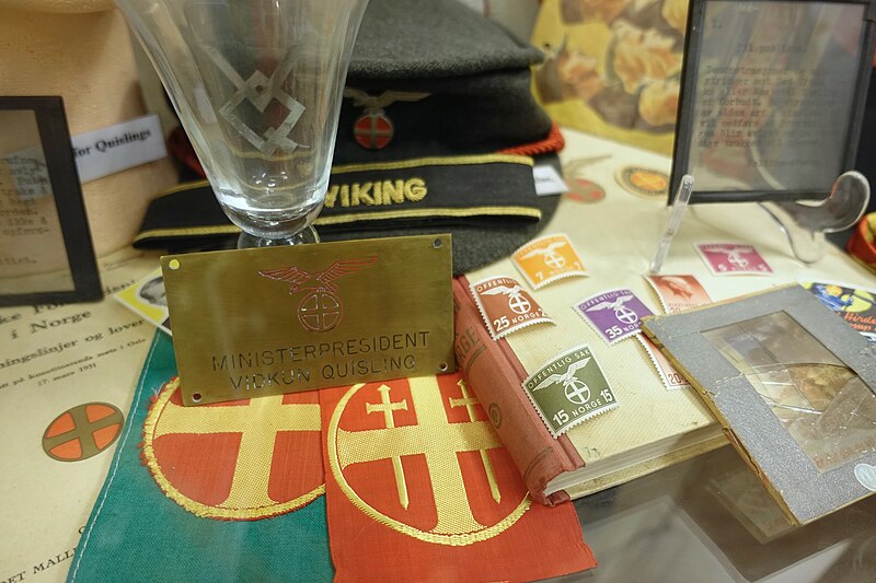 File:WW2 Norway. NS (Nazi party Nasjonal Samling) items, ministerpresident Quisling sign, suncross armlets, "Offentlig sak" stamps, VQ glass, etc. Lofoten Krigsminnemuseum 2019-05-08 DSC09998.jpg