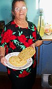 Old woman holding tortillas