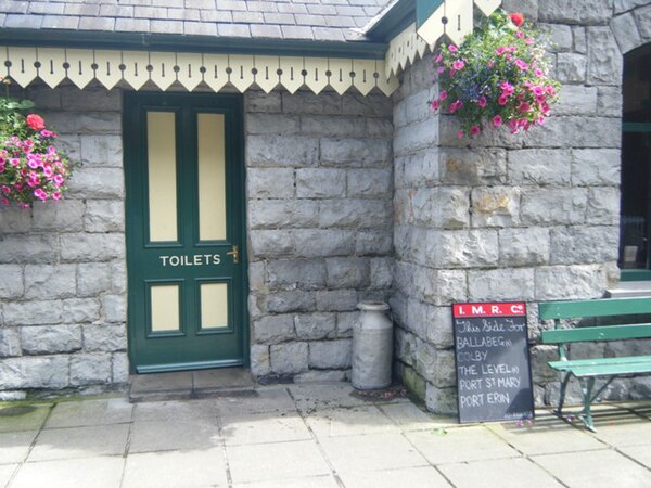 Detail of the building with period milk churn and blackboards