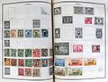 Chinese postage stamps on album pages.jpg
