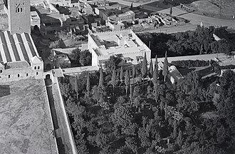Dar Moulay Ali, seen in an aerial photograph in 1930-31, near the Kutubiyya Mosque (partly visible in the upper left). The main residence (upper middle) is visible, as is the former riad garden (upper right) which formed its main entrance on its east side. A larger garden was located on its south side (middle and lower right). Dar Moulay Ali (cropped from old photograph).jpg