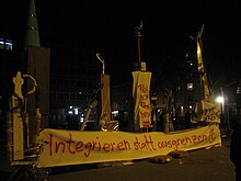 On the evening of the vote, demonstrations against the result were held in Switzerland's major cities. The banner beneath the makeshift minarets reads: "Integrate rather than exclude." Demo minarette01.jpg