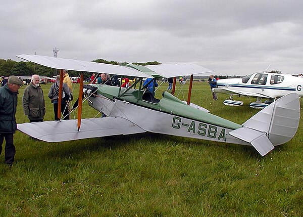 A drooped elevator, nearly touching the grass, on the horizontal stabilizer of this Currie Wot biplane
