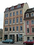 Apartment building with a shop area in closed development