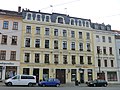 Residential building with shops in closed development and workshop building in the courtyard