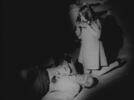 A young zombie (Kyra Schon) feeding on human flesh, from Night of the Living Dead (1968)