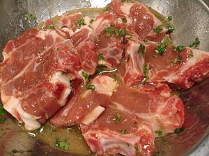 Raw goat chops in an apricot glaze about to be cooked Goat chops.jpg