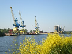 Sur la rive droite (Est) du Canal de Caen à la mer, le quai de la ZI Caen-Canal, avec ses grues et les silos à blé d'Agrial.