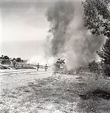 Pakistani Sherman medium tanks and infantry push forward while under fire. Indo-Pakistani War of 1965.jpg