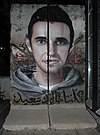 Khaled Said Graffiti on Berlin Wall.jpg