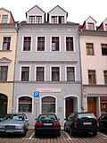 Residential house (formerly with a restaurant) in closed development, with side wing in the courtyard