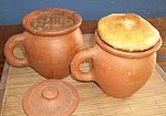 Lobio in clay pots covered with mchadi.jpg