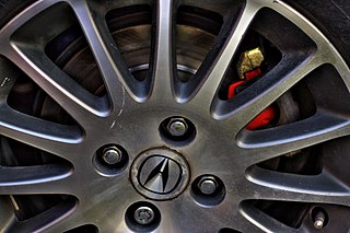 Lug nut Fastener, specifically a nut, used to secure a wheel on a vehicle