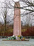 Memorial to the victims of fascism, with obelisk, surrounding wall, pedestal, cherry tree avenue, three plane trees and meadow